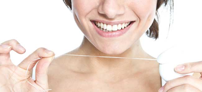 A young woman in Marietta, OH smiling after flossing.