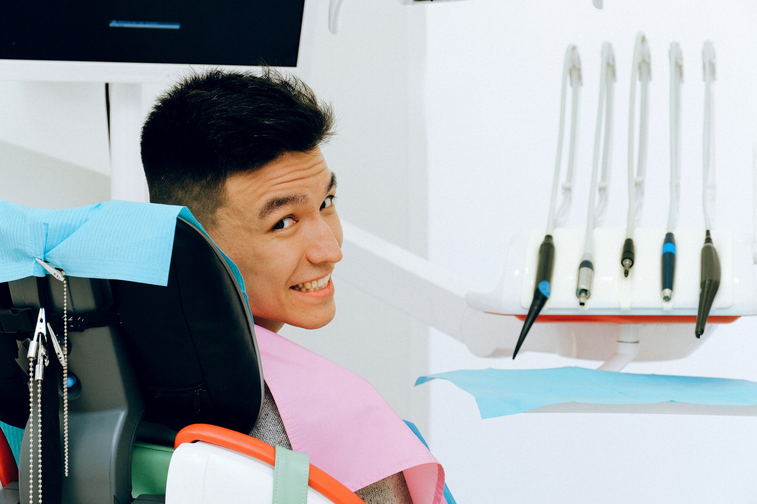 Relaxed young patient smiling in the dental chair during a back to school checkup